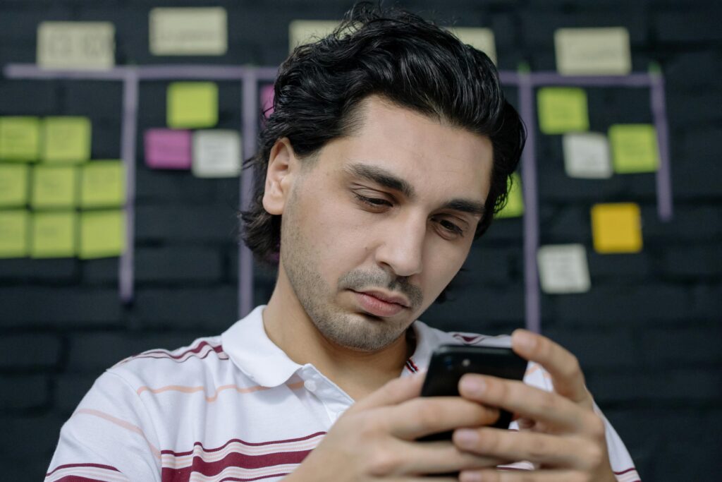 A business owner using looking at their website on their phone.