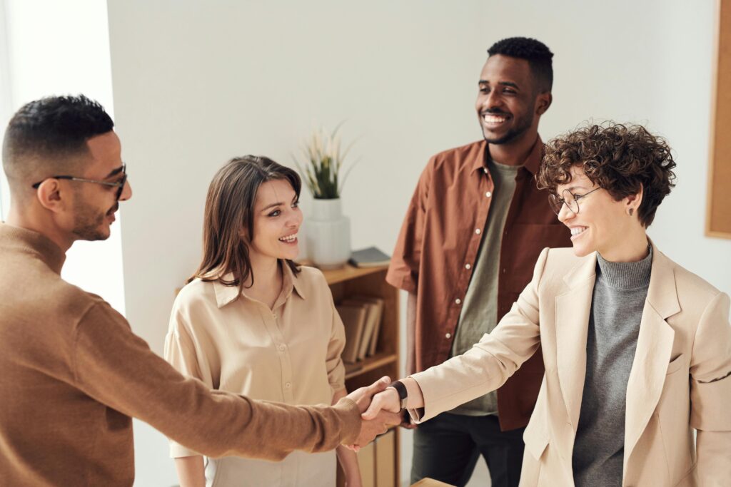 Young professionals shaking hands.