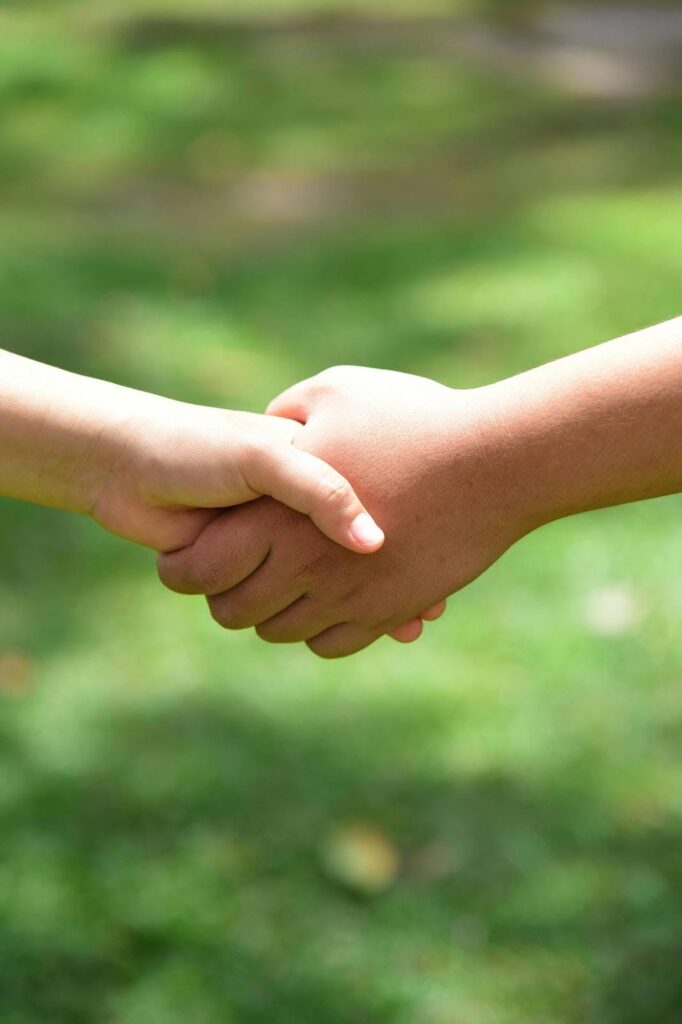 Handshake representing the relationship built between business and customer in reputation management.