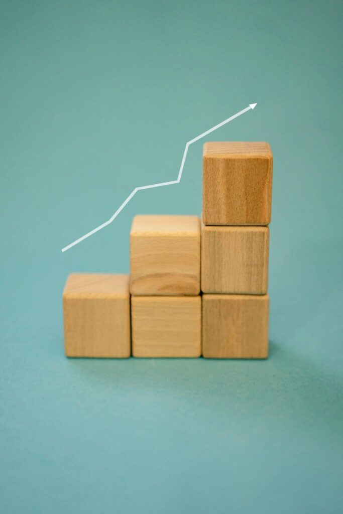 Graph line going up stepping blocks representing the steps taken to refine keyword strategy. Such as implementing long tail keywords.