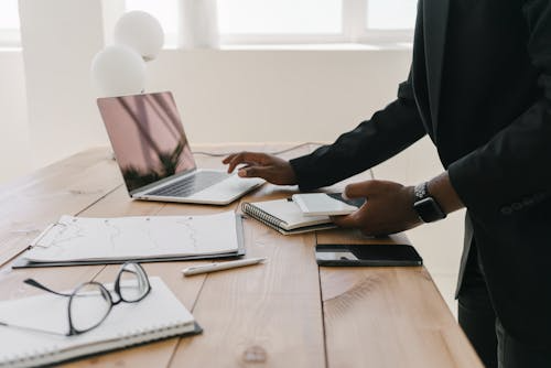 Business professional reviewing consistent brand messaging across multiple platforms, including laptop, tablet, and smartphone