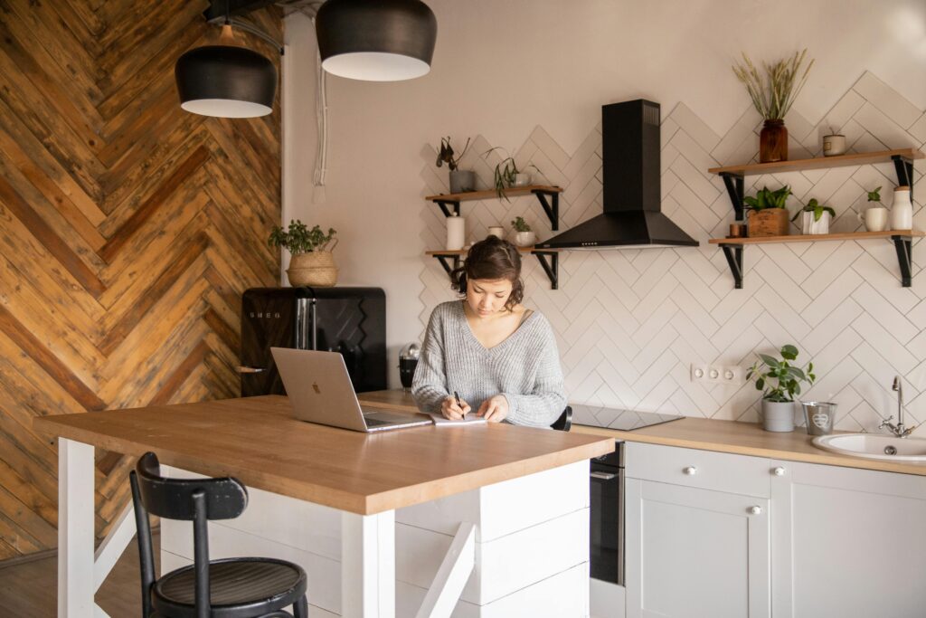 Small business owner sitting at a table on her laptop.